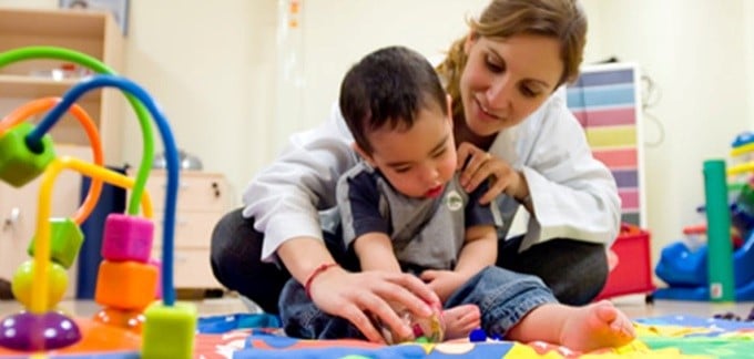 Image of a child and physical therapist